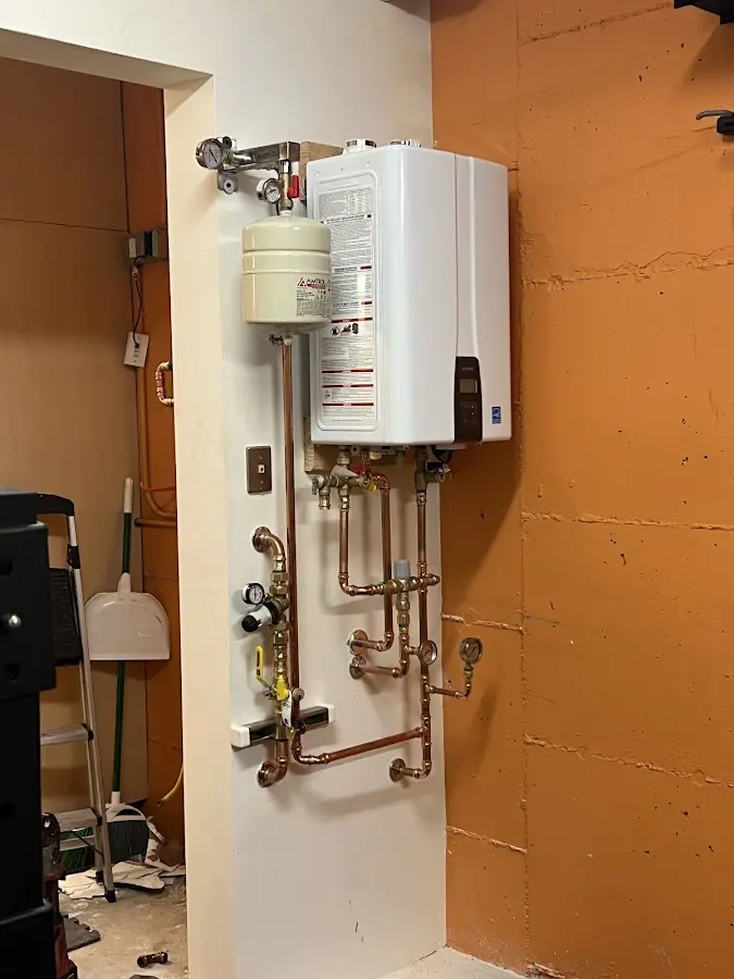 Plumbing technician inspecting water heater connections in Oak Forest